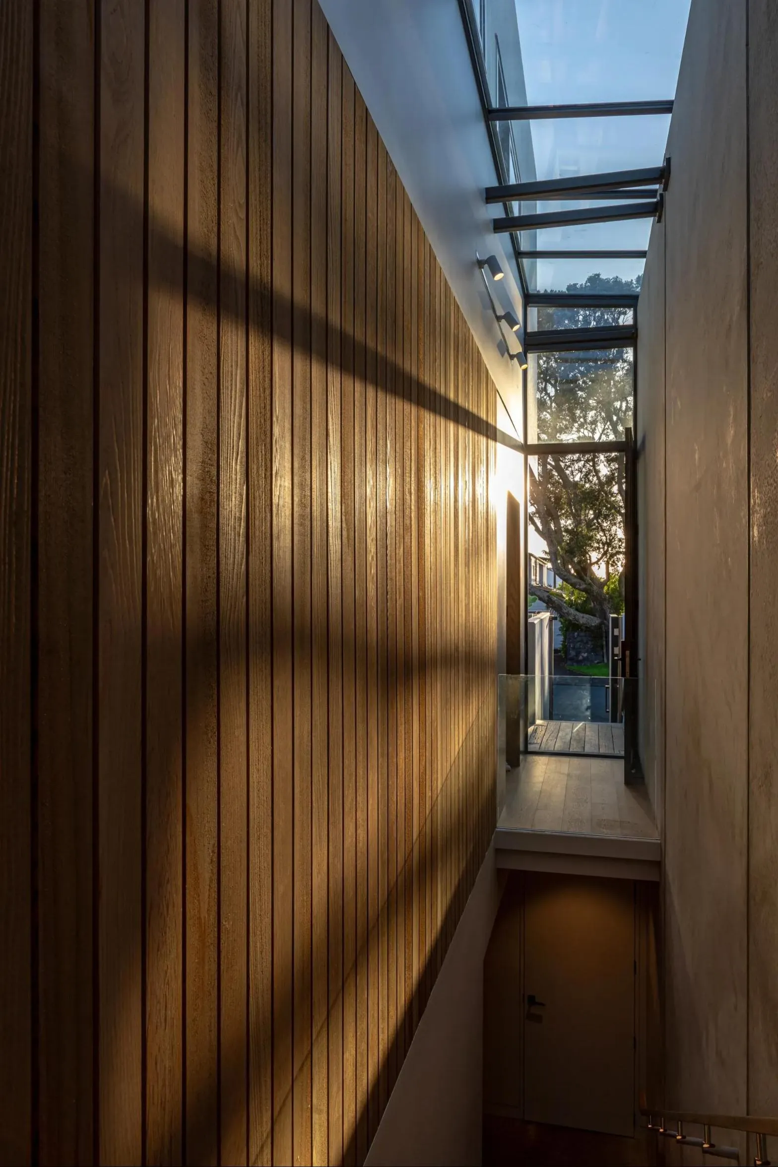 Cedar-lined stairwell under a long skylight